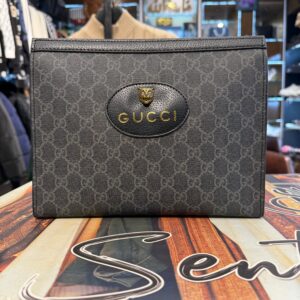 black designer pouch with animal head emblem